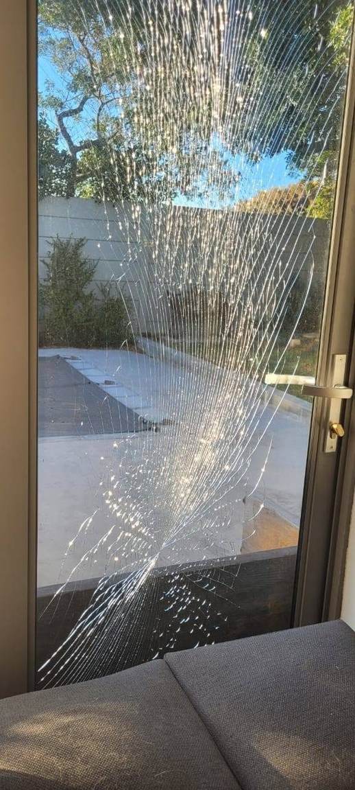 A cracked pane of glass in an aluminium door