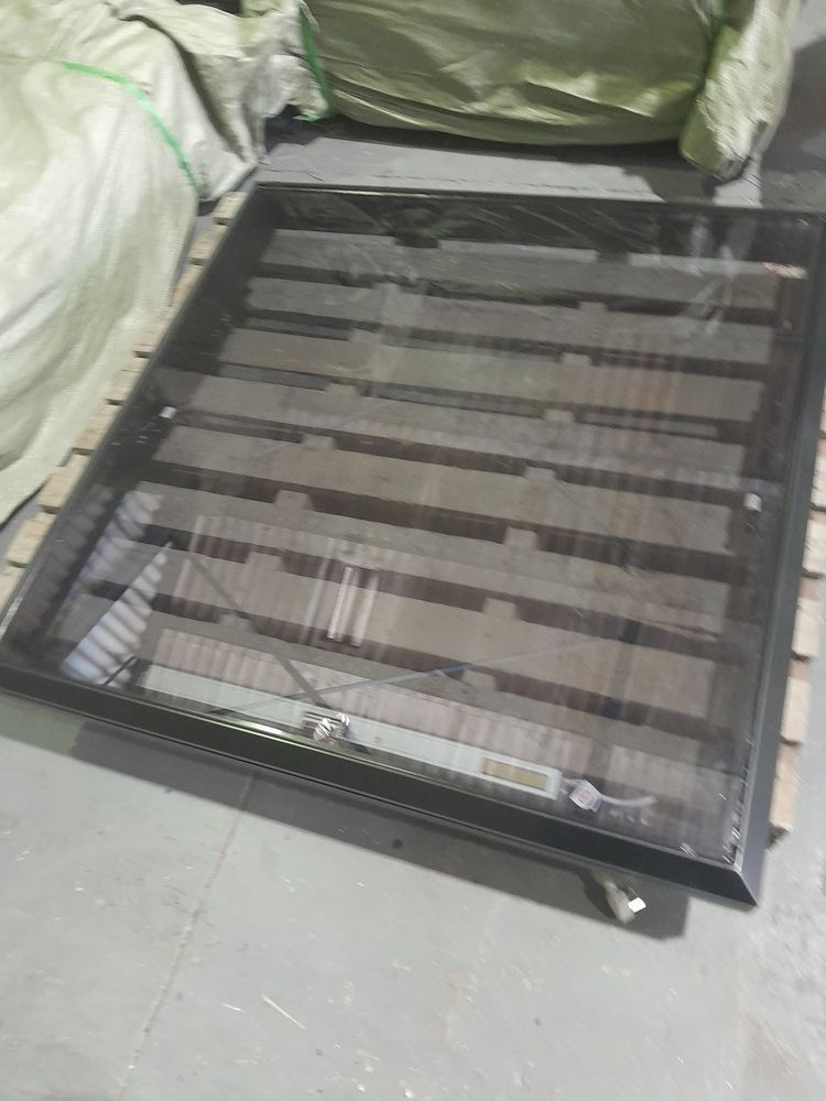 A new black aluminium frame with glass in the workshop