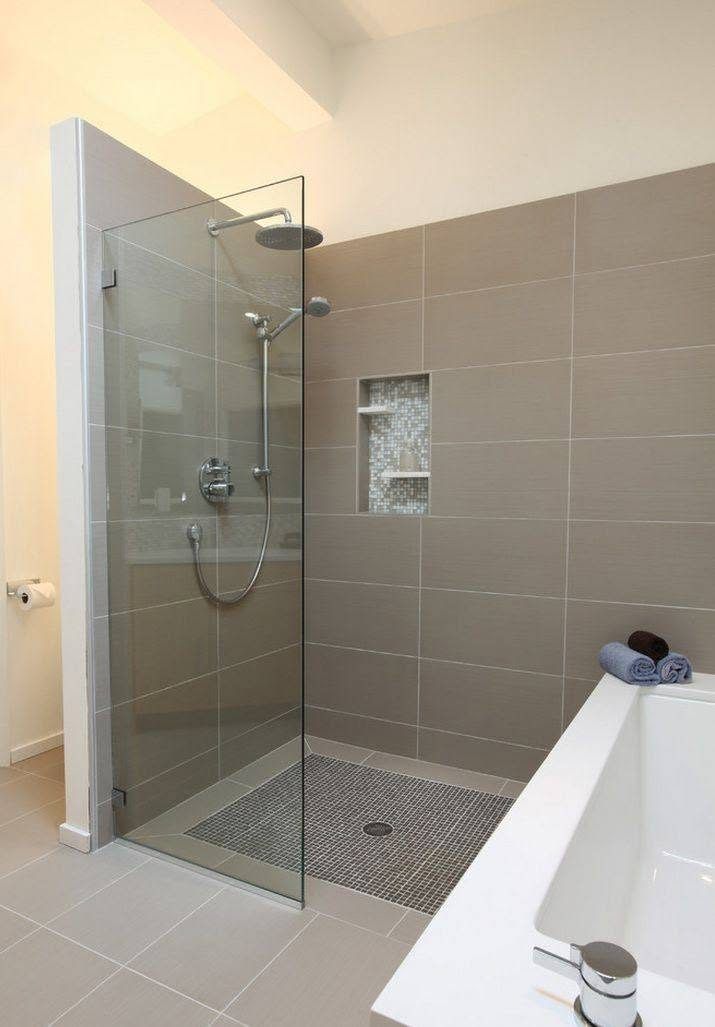 A frameless glass shower screen in a tiled bathroom