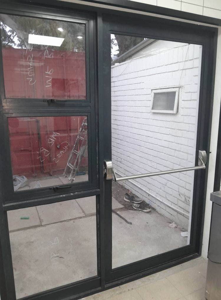 Black aluminium double doors with glass and a push bar