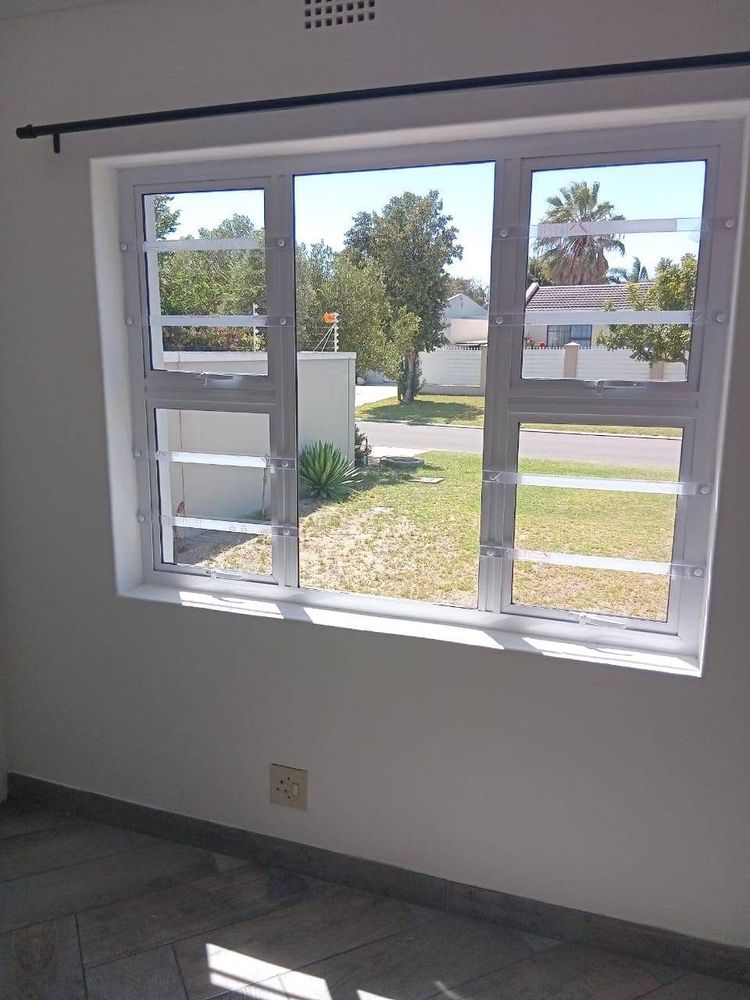 White aluminium windows with top-opening sashes, seen from inside